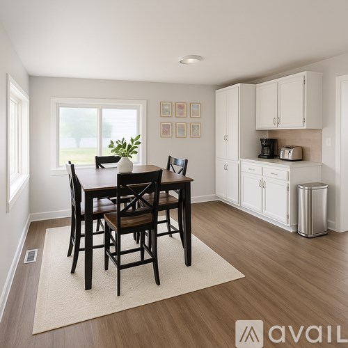 A dining room with a table set for four.