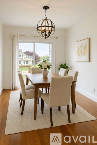 A dining room with a table and chairs.