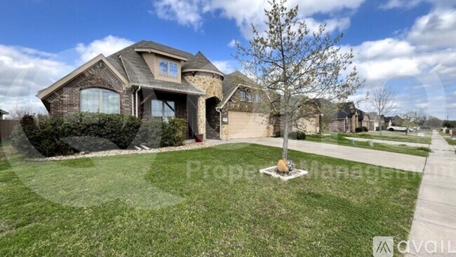 A house with a well-maintained lawn and a clear sky above.