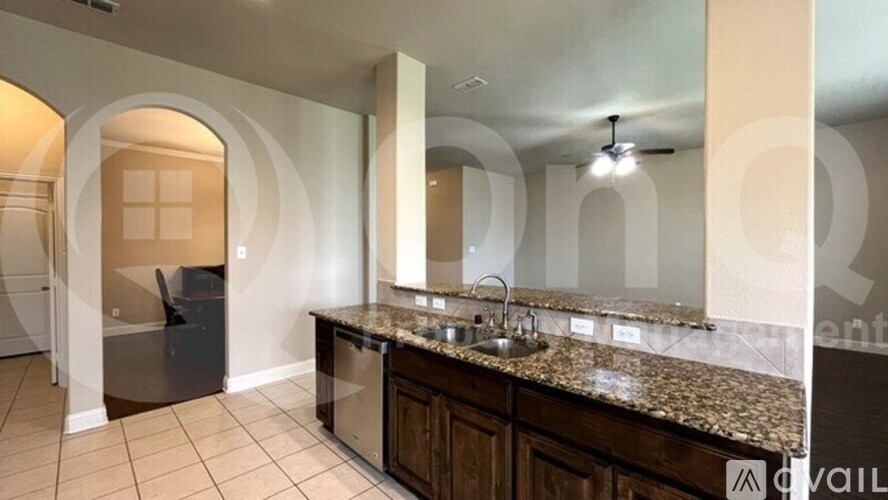 A kitchen with granite countertops and a sink.