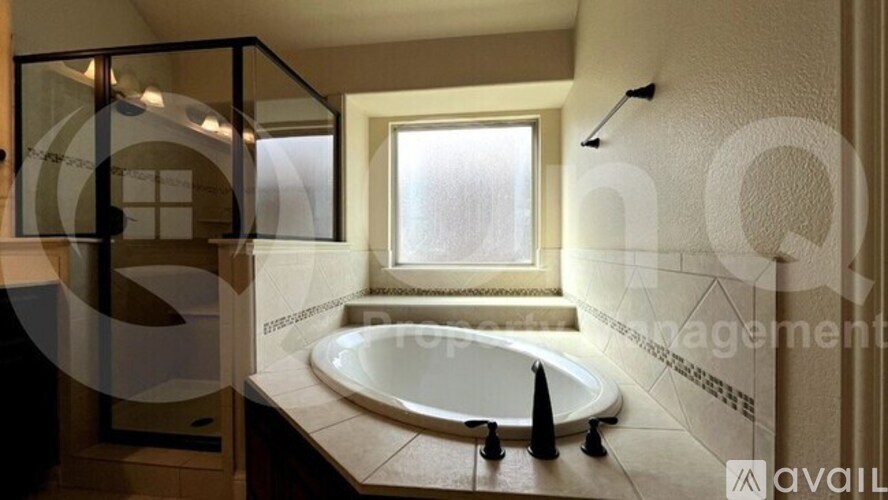 A modern bathroom with a large tub and a window.
