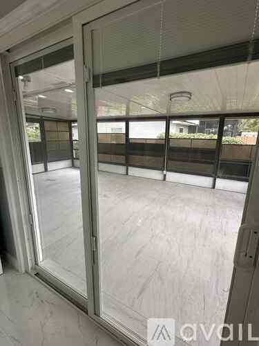 A glass door with a metal frame is open.