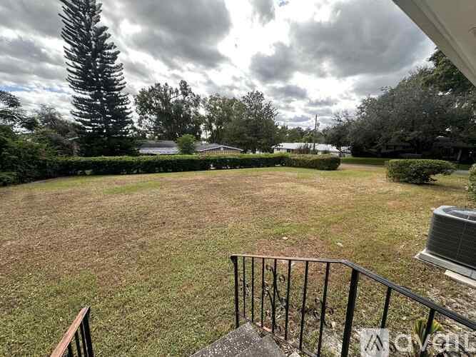 A backyard with a lawn and trees.