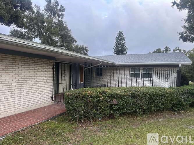 A house with a grey roof and a brick wall.