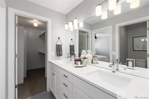 A bathroom with a white sink and a mirror above it.