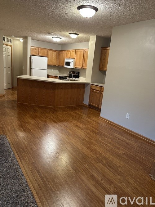 A room with wooden flooring and a staircase.