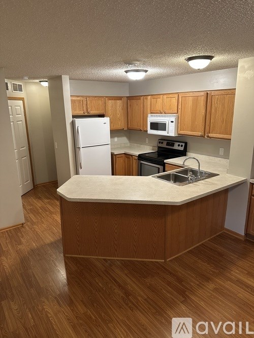 A kitchen with wooden cabinets and a white refrigerator.