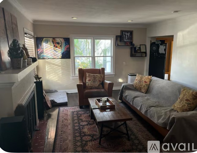 A living room with a couch, chair, and a rug.
