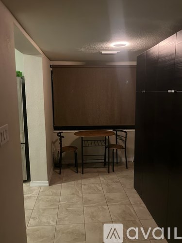 A room with a table and chairs in it.