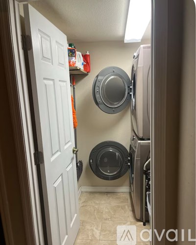 A small laundry room with a washer and dryer.