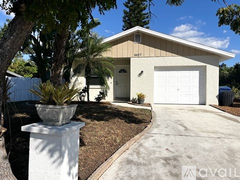 A house with a white garage door and a driveway.