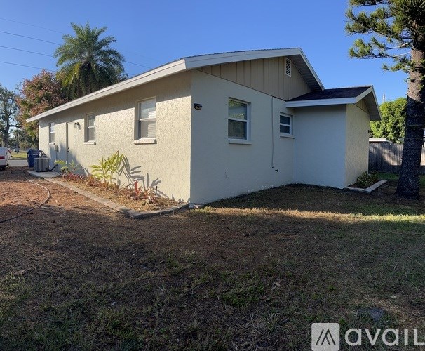 A house with a beige exterior and a brown roof.