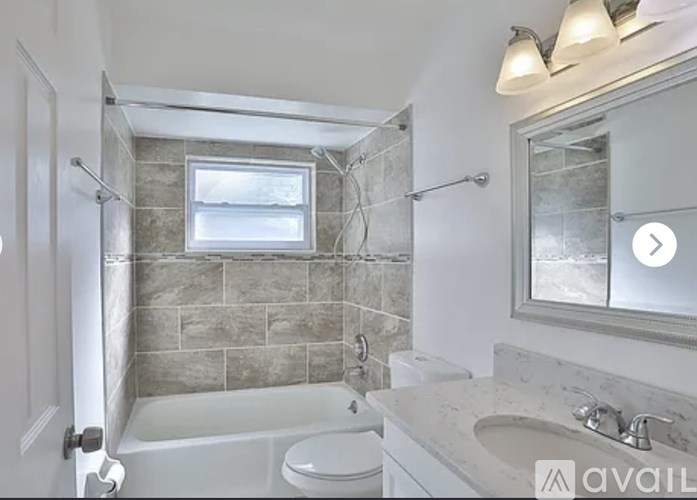 A bathroom with a white toilet, a white sink, and a glass shower door.