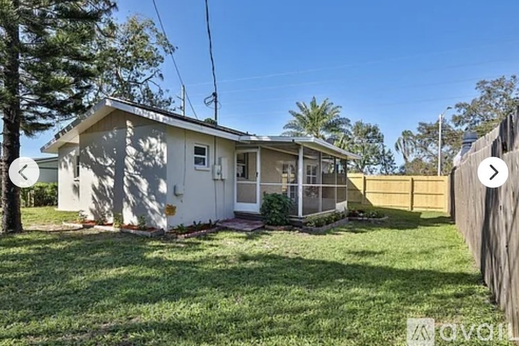 A house with a white exterior and a brown fence.