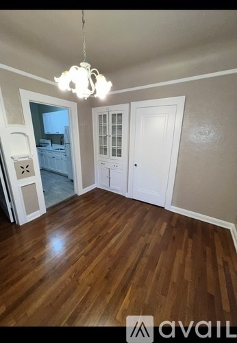 A room with wooden floors and a chandelier.