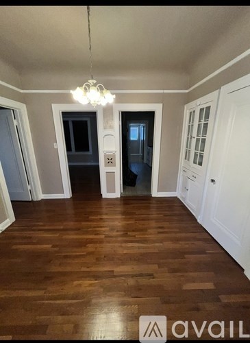 A room with wooden floors and white walls.