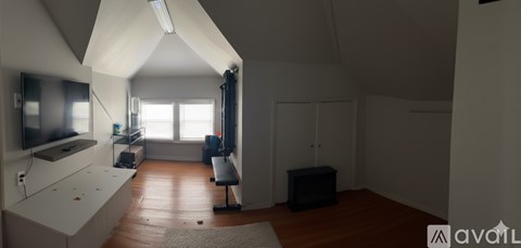 A living room with a television and a couch.