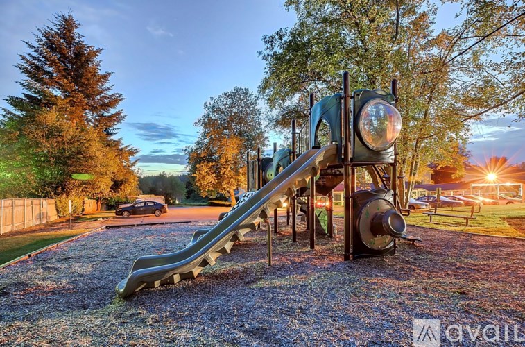 A playground with a slide and a train-themed structure.
