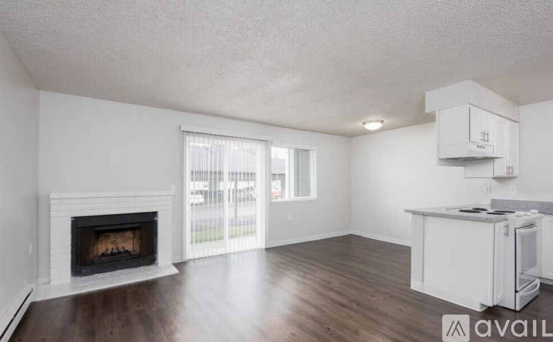 A spacious living room with a fireplace and sliding glass doors.