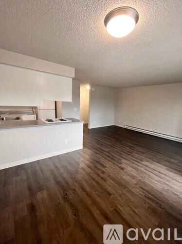 A room with wooden floors and white walls.