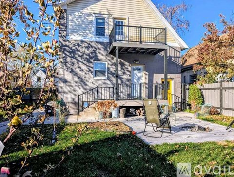 A house with a balcony and a yellow door.