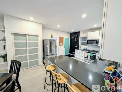 A modern kitchen with a dining table and chairs.