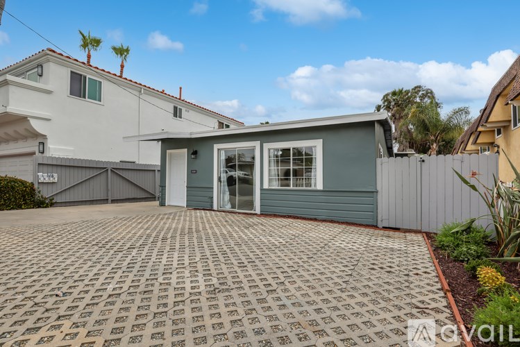 A house with a grey garage door and a grey house next to it.