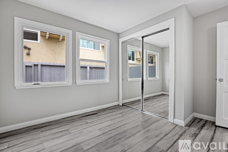 A room with a view of a building through the window.