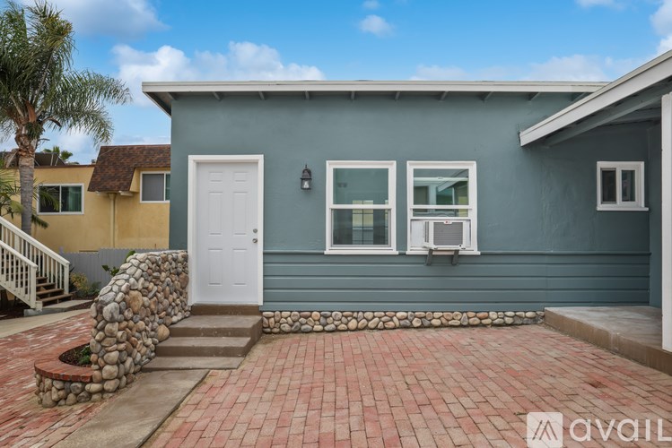 A house with a white door and windows is for sale.