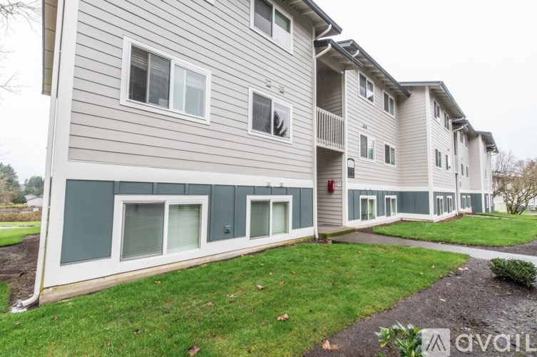 Apartment building with a grassy area in front.