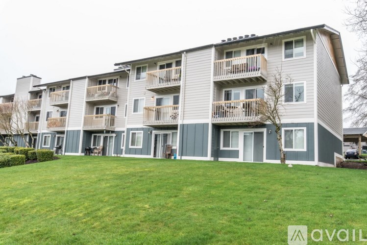 Apartment building with a green lawn in front.