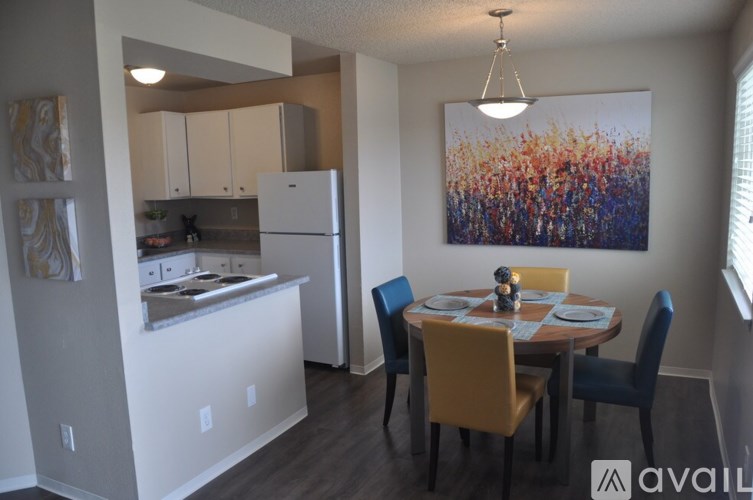 A kitchen with a dining table and chairs.