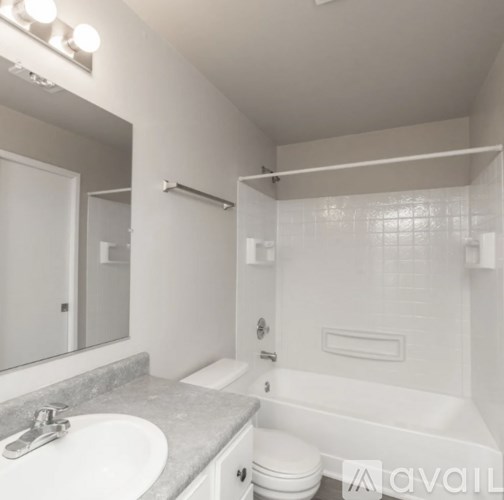 A bathroom with a sink, toilet, and bathtub.