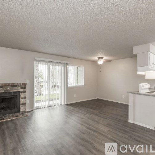 A living room with a fireplace and sliding glass doors.