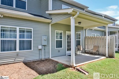 A house with a covered patio and a small garden.