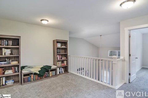 A room with a white crib and a bookshelf filled with books.
