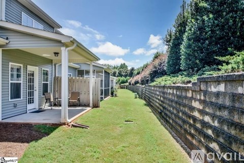 A row of houses with a grassy area in between.