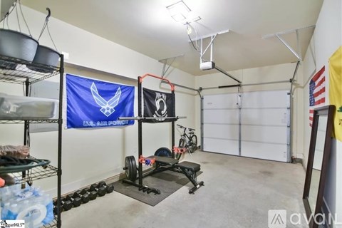 A garage with a blue flag and a black flag hanging on the wall.