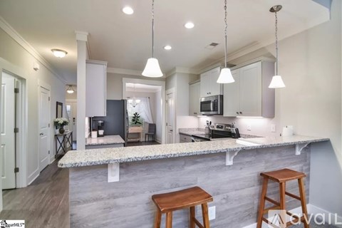 A kitchen with a bar area and a bench.
