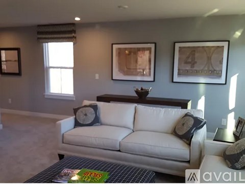 A living room with a white couch and a coffee table.