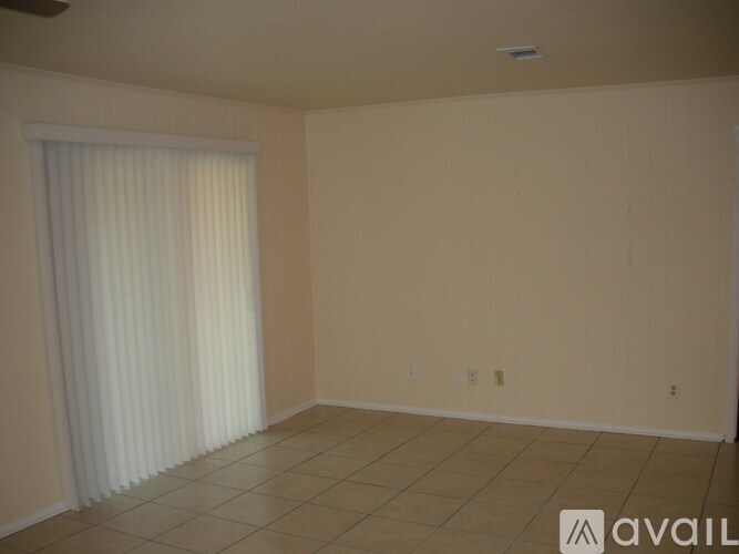 A room with beige walls and a tiled floor.