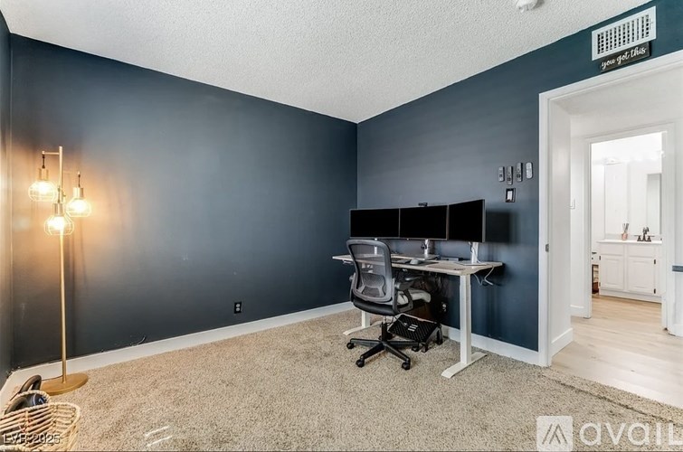 A room with a desk and a chair.