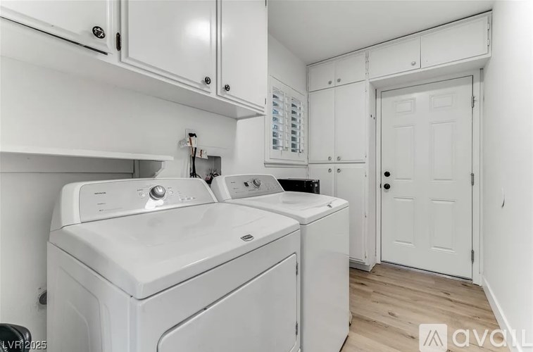 A white washing machine and dryer in a laundry room.