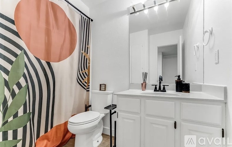 A bathroom with a white toilet and a white sink.