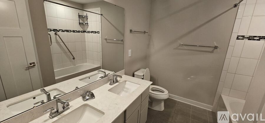 A bathroom with a toilet, sink, and mirror.