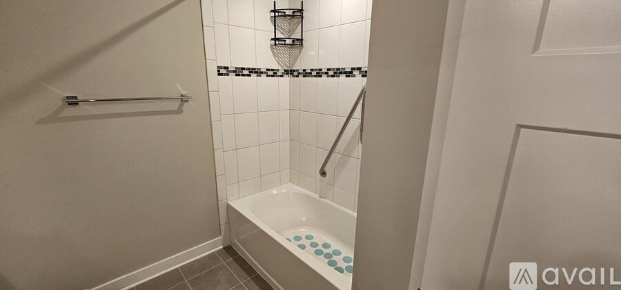 A bathroom with a white tub and a white door.