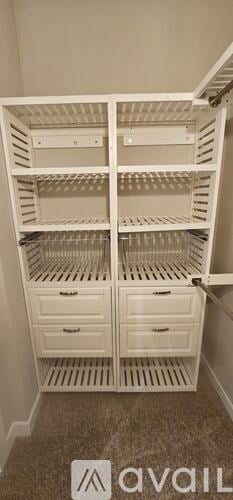 A white double pantry with two drawers and two shelves.