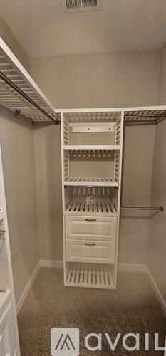 A white closet with shelves and drawers.