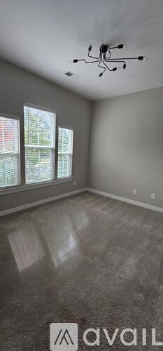 A room with a ceiling fan and a window.