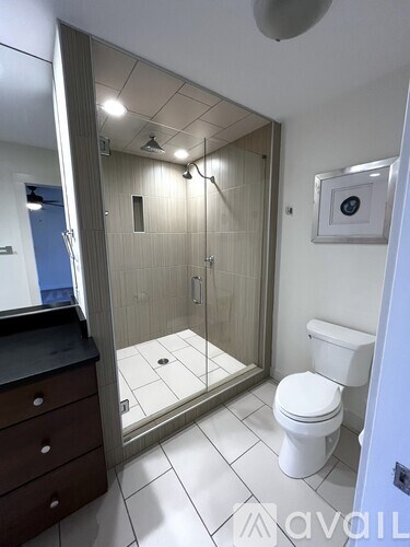 A bathroom with a toilet, sink, and shower.